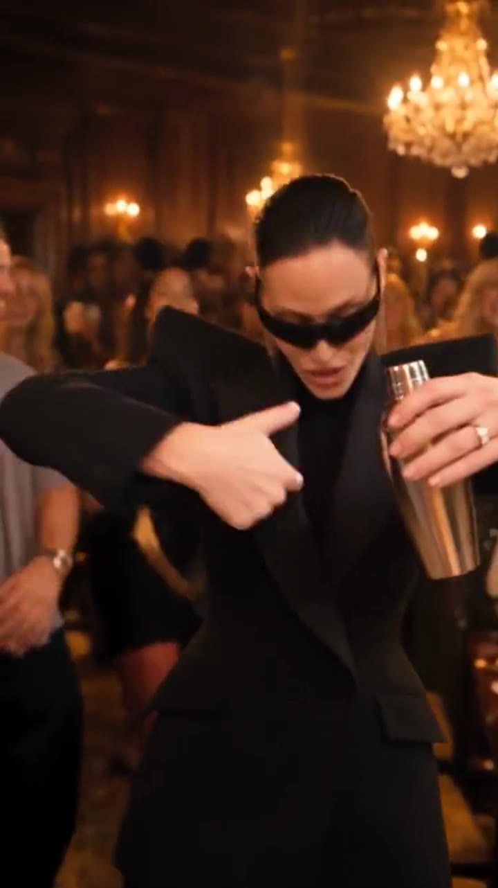 Burning Bridges AI example: a guest in a black blazer and sunglasses leading the party